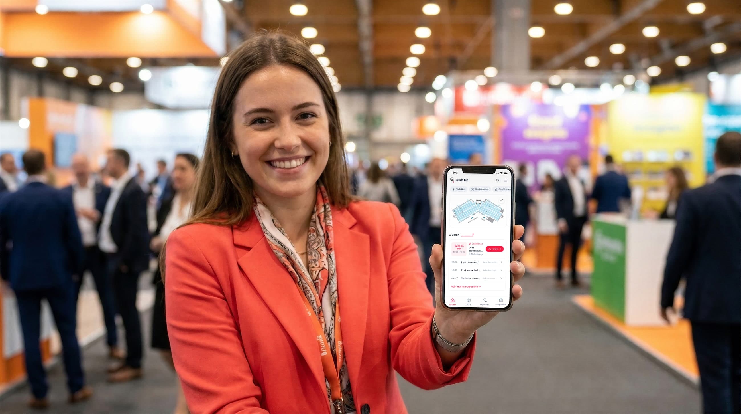 A smiling visitor shows the show’s app on her phone: the floor plan and the countdown to the next conference